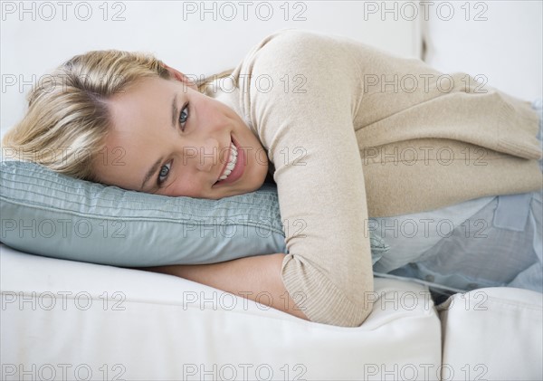 Woman laying on sofa.