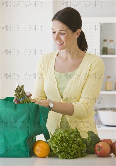 Woman unpacking groceries.