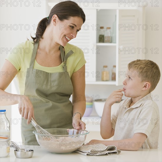 Mother and son making batter.