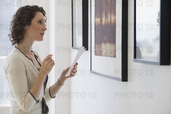 Woman looking at art in art gallery.