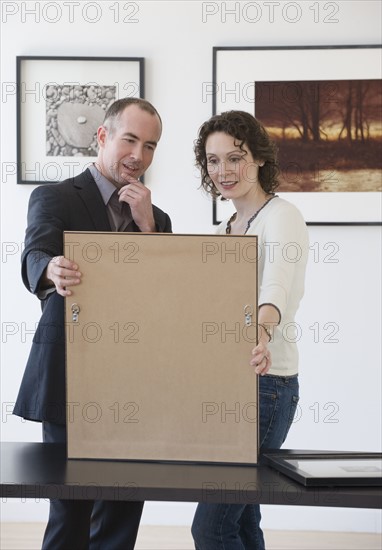 Couple looking at art in art gallery.