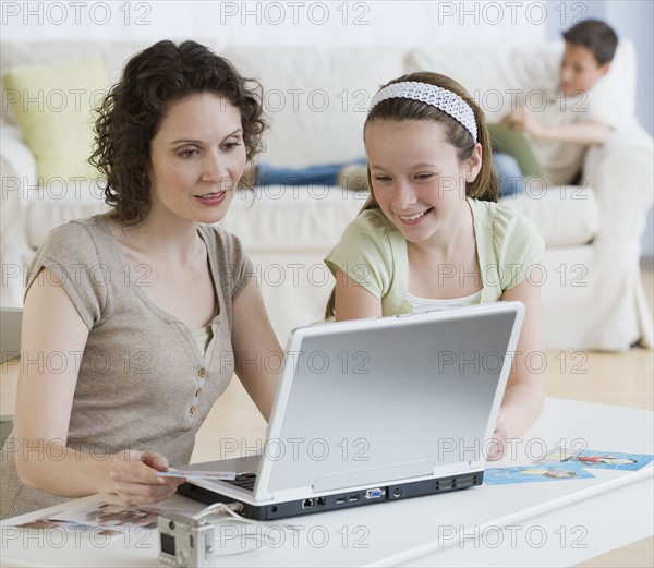 Mother and daughter looking at laptop.