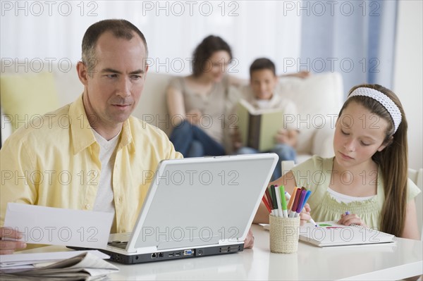 Family relaxing in living room.