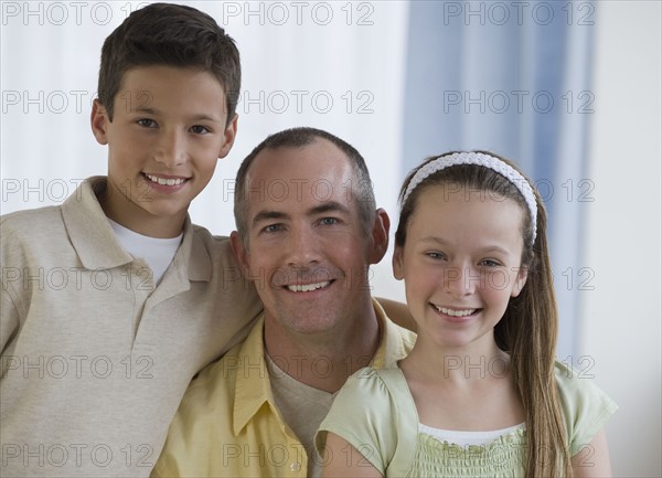 Father and children hugging.