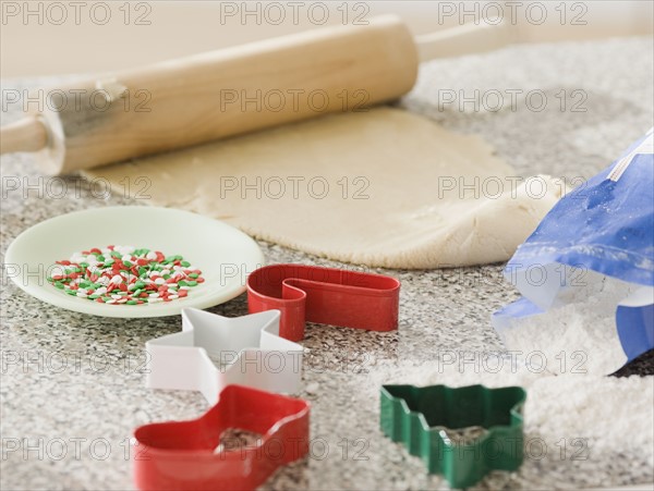 Cookie dough and cookie cutters on counter. Date : 2008