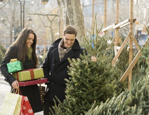 Couple shopping for Christmas trees. Date : 2008