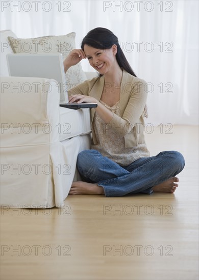 Woman looking at laptop.