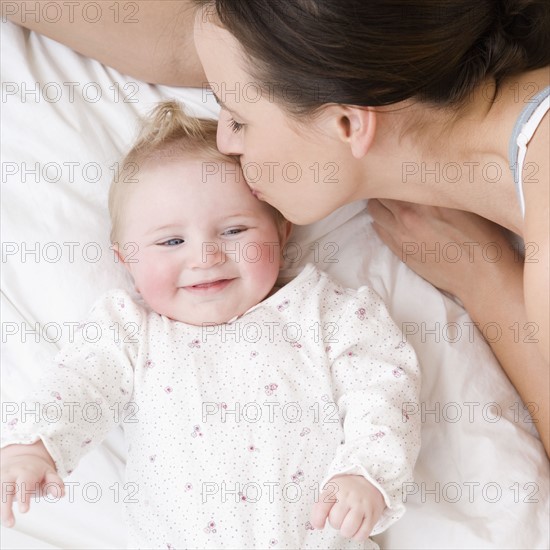 Mother kissing baby on head. Date : 2008