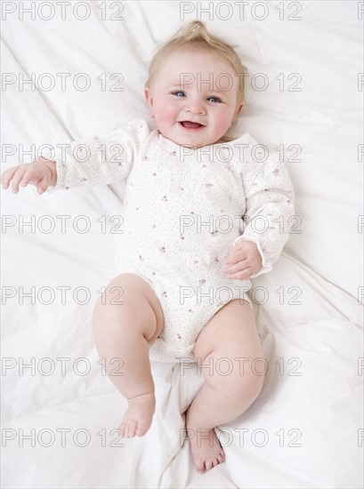 Baby laying on bed. Date : 2008