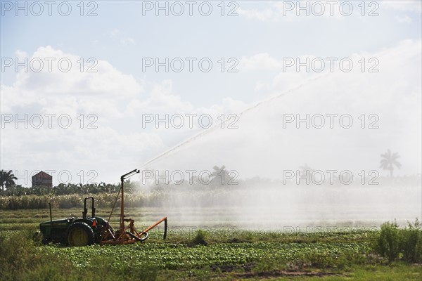 Tractor watering field, Florida, United States. Date : 2008