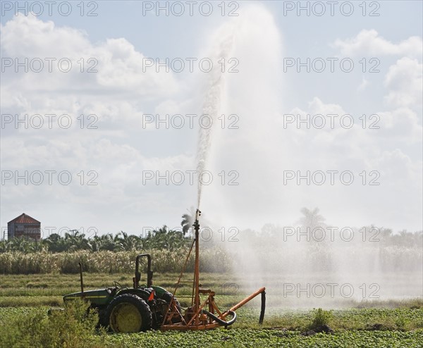 Tractor watering field, Florida, United States. Date : 2008