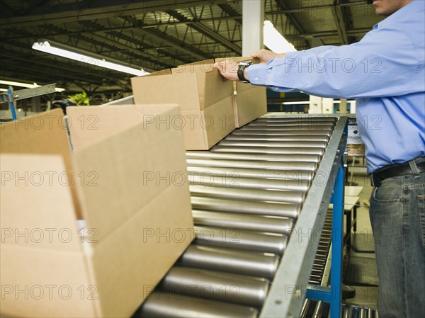 Asian male factory worker checking product. Date : 2008