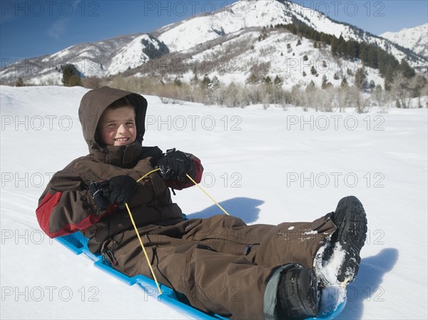 Boy riding on sled. Date : 2008