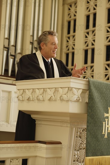 Priest standing at pulpit. Date : 2008