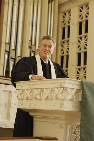 Priest standing at pulpit. Date : 2008