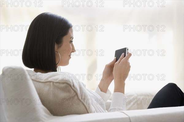 Woman looking at cell phone. Date : 2008
