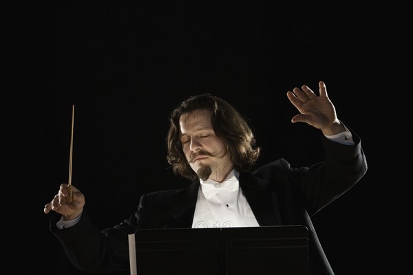 Man conducting behind music stand. Date : 2008