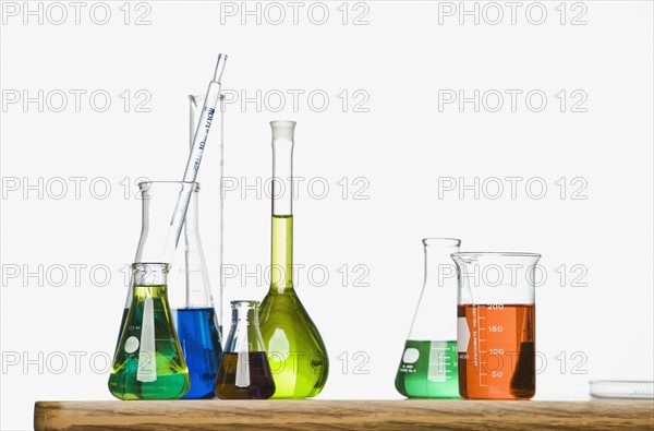 Science beakers with liquid on table. Date : 2008