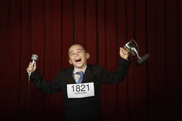 Boy wearing number and holding trophy. Date : 2008