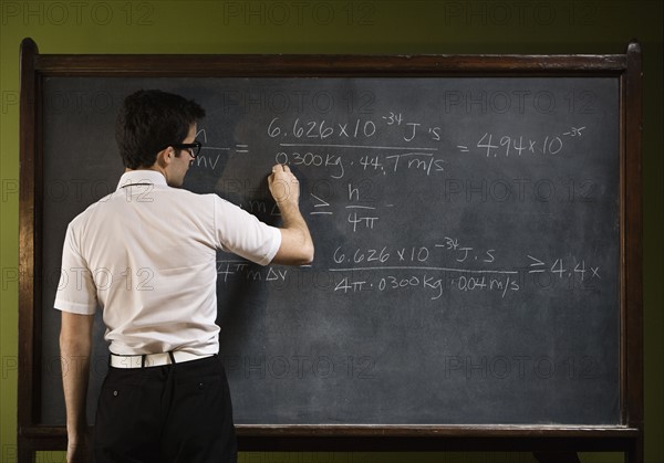 Man writing on blackboard. Date : 2008