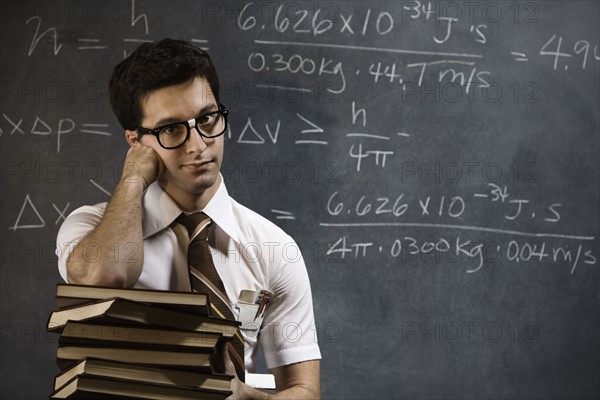 Nerdy man in front of blackboard. Date : 2008