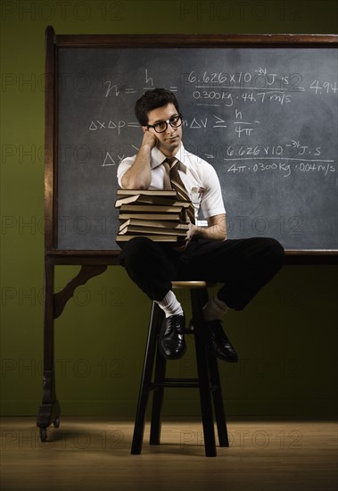 Nerdy man in front of blackboard. Date : 2008