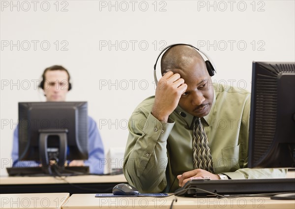 African businessman wearing headset. Date : 2008