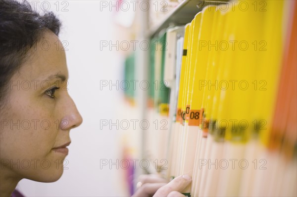 Woman looking at folders. Date : 2008