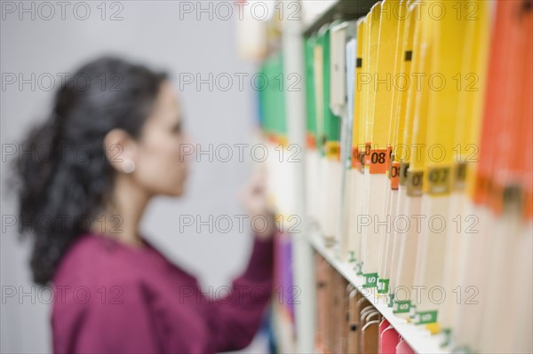 Woman looking at folders. Date : 2008