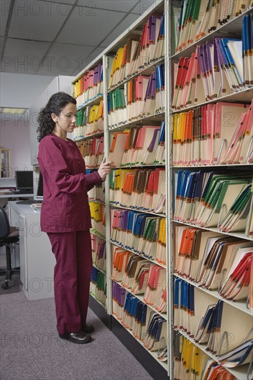 Female doctor looking at charts. Date : 2008