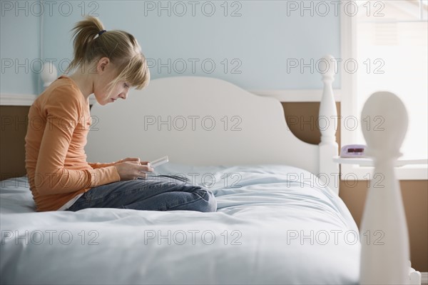 Girl playing handheld video game. Date : 2008