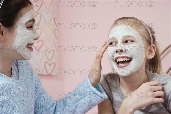 Girl applying facial treatment to friend. Date : 2008