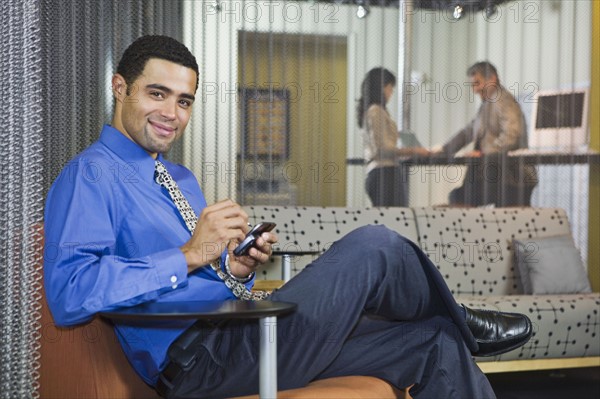 African businessman dialing cell phone. Date : 2008