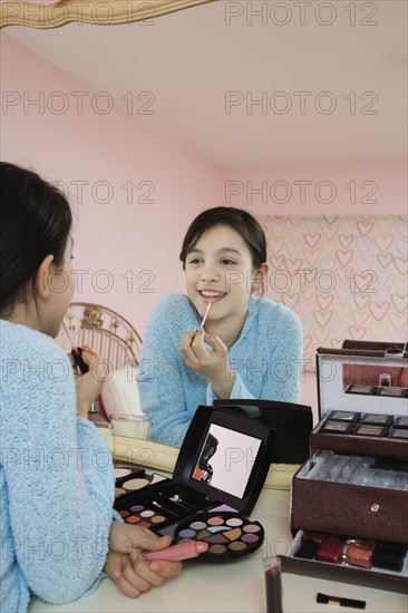 Girl applying lip gloss. Date : 2008