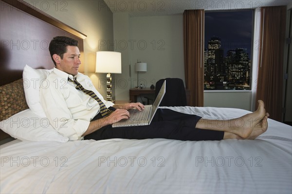 Businessman typing on laptop. Date : 2008