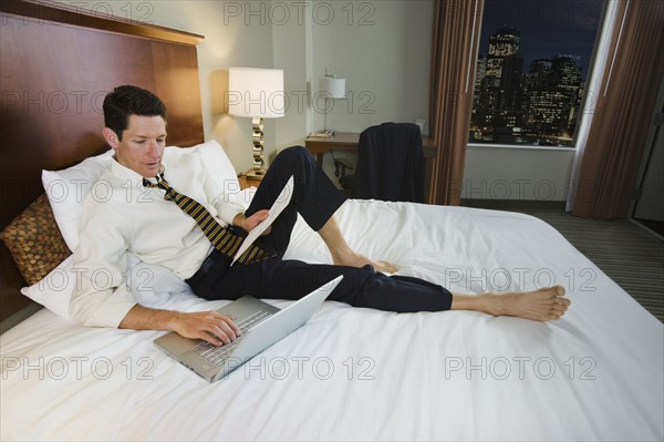 Businessman typing on laptop. Date : 2008
