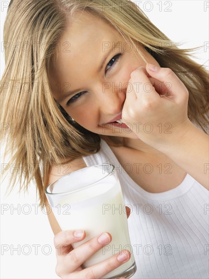 Woman holding glass of milk. Date : 2008