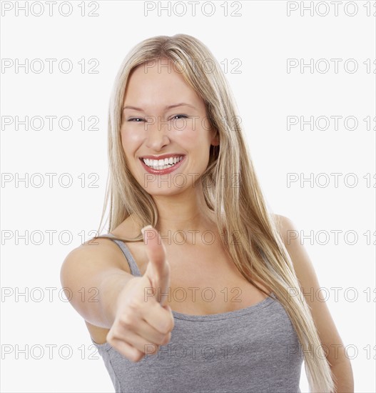Woman giving thumbs up. Date : 2008