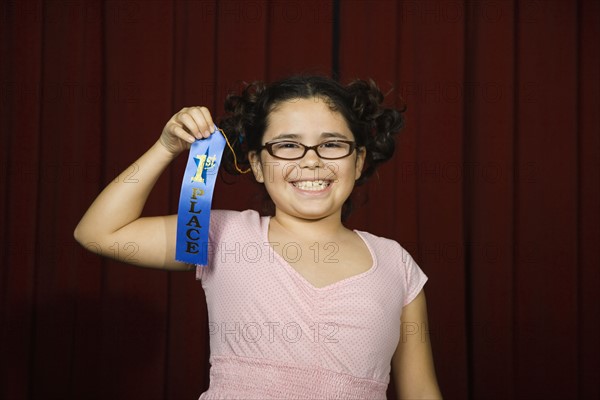 Girl holding first place ribbon on stage. Date : 2008