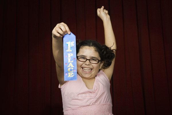 Girl holding first place ribbon on stage. Date : 2008