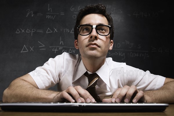 Nerdy man in front of blackboard. Date : 2008