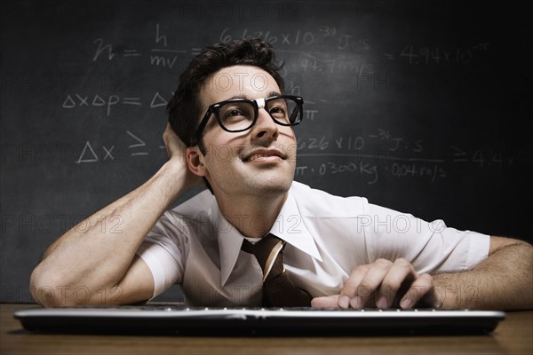 Nerdy man in front of blackboard. Date : 2008