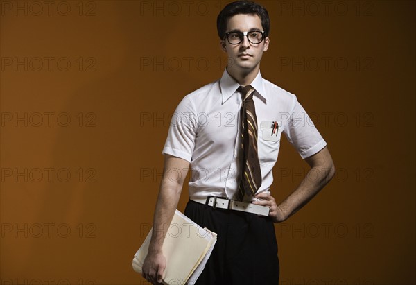 Nerdy man holding school books. Date : 2008