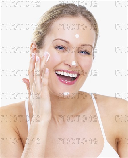 Woman applying face cream. Date : 2008