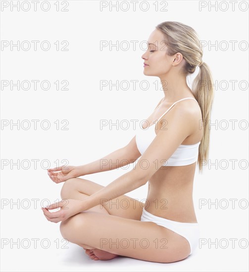 Woman in underwear meditating. Date : 2008