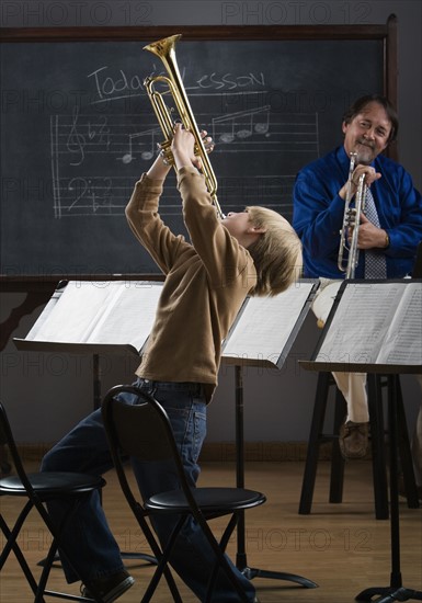Boy playing trumpet in classroom. Date : 2008