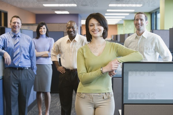 Businesswoman with multi-ethnic coworkers in background. Date : 2008