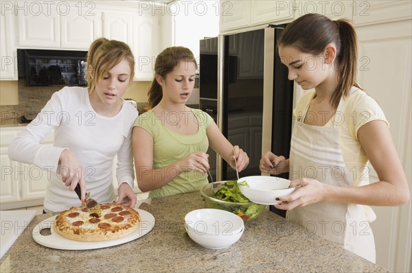 Teenaged girls serving food. Date : 2008