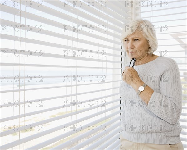 Woman looking out window. Date : 2008