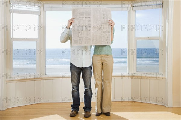 Couple reading newspaper. Date : 2008